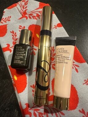 Estee Lauder gold, black, and cream skincare trio